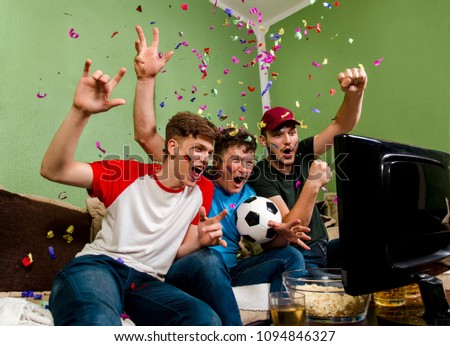 Cheerful family watching soccer cup on television, confetti in the air, success, winning concept
