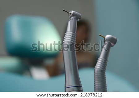 Dentists drills selective focus on first one, chair and patient blurred in the background