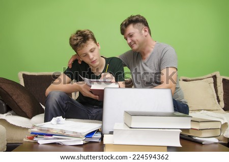 Father doing homework with his son