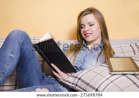 Girl preferred reading a book, over using tablet and modern technology