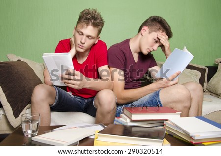 Two teenagers overwhelmed with studying, having trouble focusing. Too much homework.