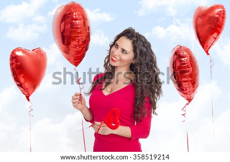 Saint Valentines concept, beautiful girl, holding helium heart shaped balloon and smiling, beautiful clouds background photo manipulation