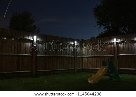 Backyard with solar lights at night