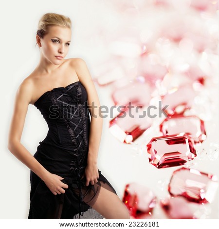 Studio fashion portrait of a sexy young girl, ruby gems on background