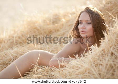 stock photo Beautiful sexy young nude woman in the hay