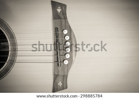 Close-up western guitar on wooden background