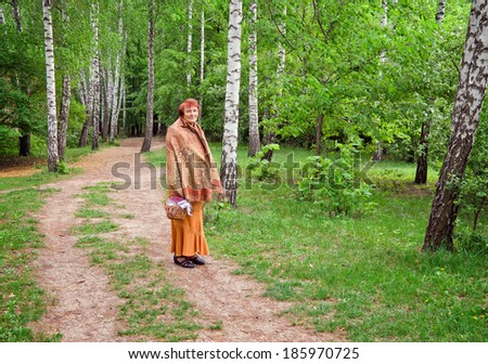 Elderly lady walks on Easter day.  Sofiyivsky Park, Uman city, Central Ukraine