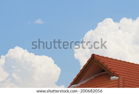 Brown tile roof in garden against blue sky.
