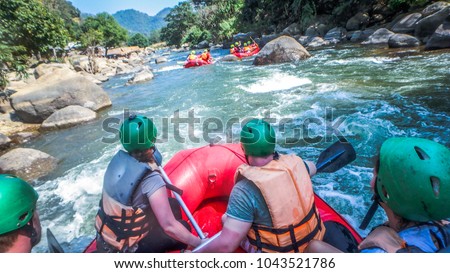 white water rafting with a team of green helmets in Thailand