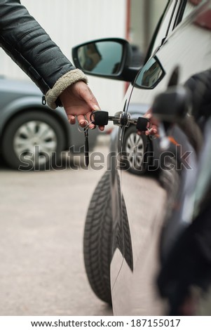 Female hand with key opens car door