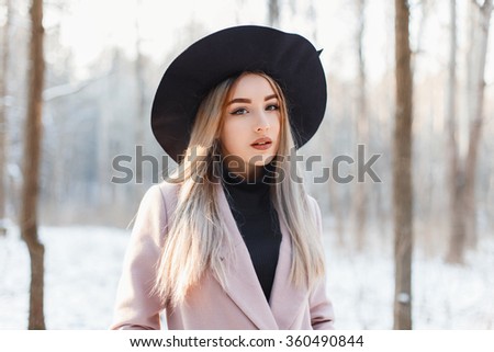 Beautiful woman on the background of a winter forest with snow