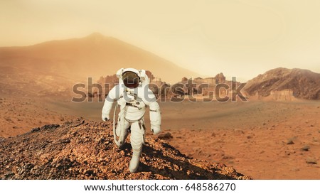 Astronaut man walks in the desert with mountains in Mars. Journey to the red planet. Landscape of the red planet Mars