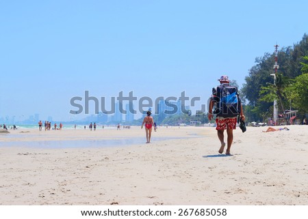 HUAHIN,THAILAND - April 2015 : View of the beach in HUAHIN, packed with people on a hot summer day on April 5 2015 in HUAHIN, THAILAND.
