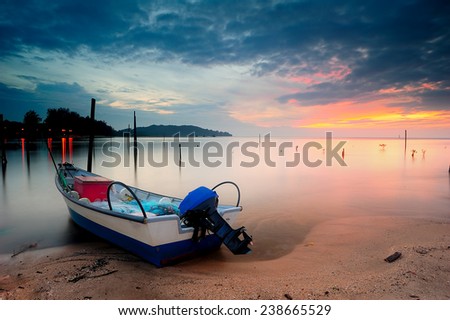 a fisherman boat at the beach. image might contain softness and little noise due to long exposure