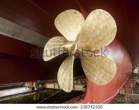 Vintage Tug Brass Propeller Vessel Mounted dry-docked old steam tug boat vessel with solid brass propeller and riveted hull metal plates visible