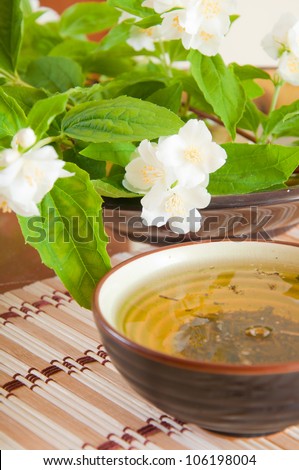 Jasmine flowers and a cup of jasmine tea