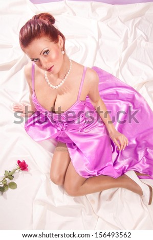 Beautiful woman in elegant dress sitting on the floor