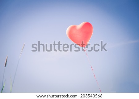 Heart shape balloon on the sky background