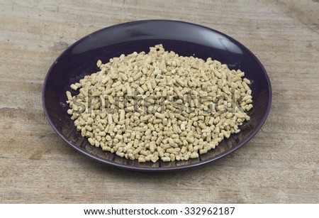 Special corn , meat and vegetable mix from all organic feed for chickens some Pelleted Compound Feed for Cattle   in plate on Wood Background.