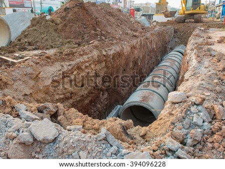 Concrete Drainage Pipe on a Construction Site .Concrete pipe stacked sewage water system aligned on site.