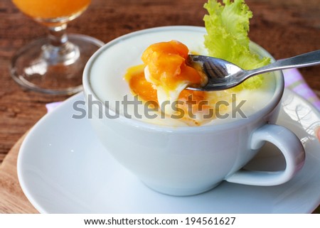 Soft boiled egg on top Steamed Egg in a cup.