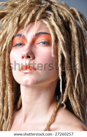 stock photo a blond model with dreadlocks and eye makeup