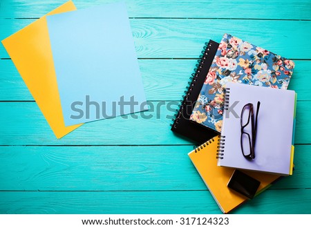 Education workspace with copy space and school accessories on blue wooden background. Top view