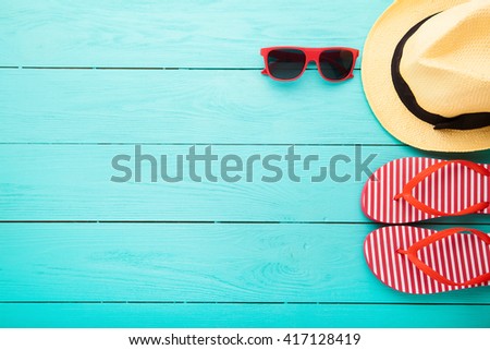 Summer accessories on blue wooden floor. Top view and copy space