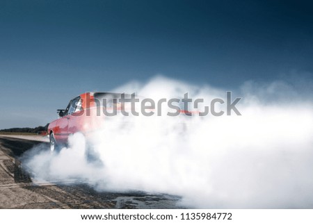 Car make tire warm up with smoke before dragrace. Burn out and warm up at the start line