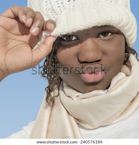 Girl playing with a white wool cap under the sun