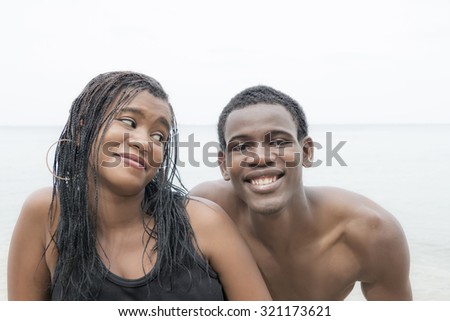 Two teenagers smiling at the beach