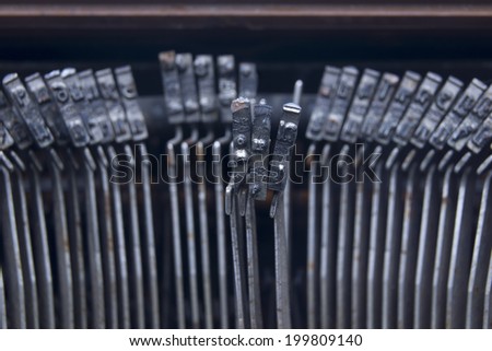Typewriter an electric, electronic, or manual machine with keys for producing print like characters one at a time on paper inserted around a roller.