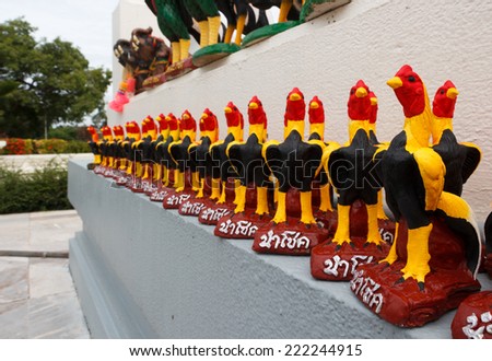 Thai Fighting roosters sculpture on the wall.