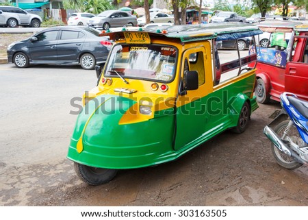 Ayutthaya Thailand - July 30 2015: Yellow and Green Auto rickshaw, Motorized tricycle park to waiting travelers at Wat Chaiwatthanaram.