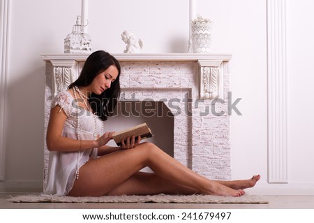 beautiful woman in underwear near the fireplace in a studio