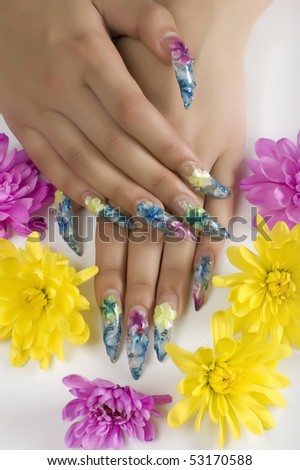 Smart nails with  beautiful manicure on the ground of flowers