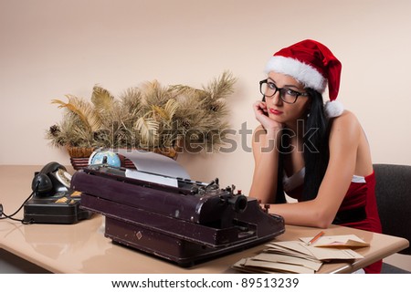 CHRISTMAS GIRL In HAT ?????, sits at office and longs.