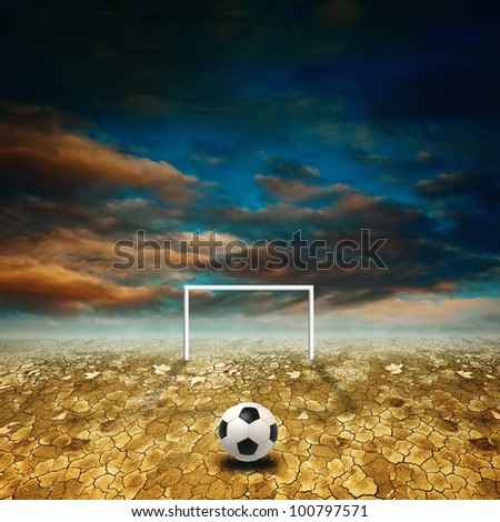 Soccer ball on a dry desert ground against a blue sky with clouds