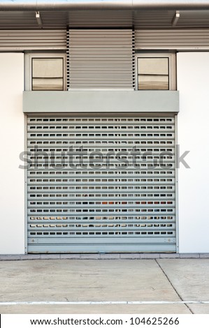 Store is closed. Metallic roll shutter door of commercial retail store.