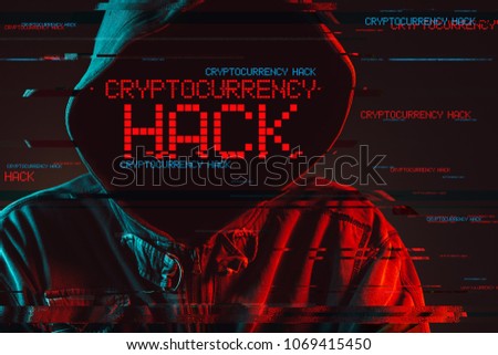 Cryptocurrency hack concept with faceless hooded male person, low key red and blue lit image and digital glitch effect