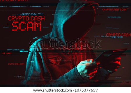 Crypto cash scam concept with faceless hooded male person using tablet computer, low key red and blue lit image and digital glitch effect