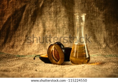 Plum brandy or schnapps with fresh and tasty plum fruit on a table cloth