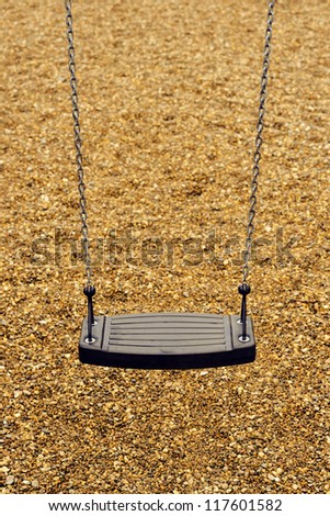 Empty playground swing in a empty park.