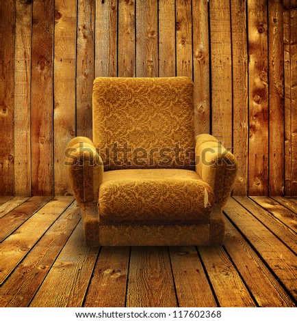 Old armchair in wooden room