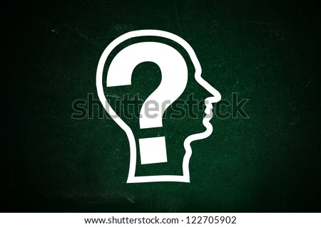 Human head made of question marks on a green chalkboard. Question everything concept: thoughts; look; smell; hear; speak.