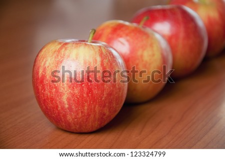 Tasty red apples on table; agriculture background image - organic food production