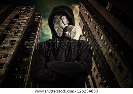 Man with military gas mask. Man in dark clothes wearing classic gas mask respirator