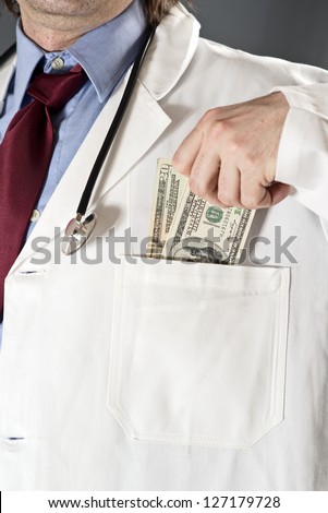 Bribed doctor - doctor taking money into his pocket. Bribe and corruption in health and medicine industry.