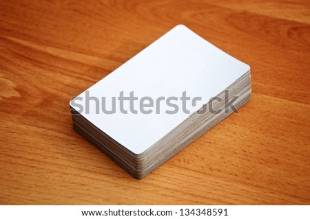 Stack of business cards with rounded corners over a wooden background