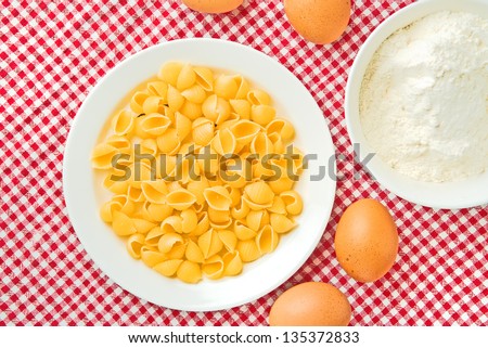 Flour, eggs and pasta  on kitchen table, raw food ingredients.